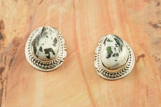 White Buffalo Turquoise set in Sterling Silver Post Earrings. This Beautiful Stone is formed from the minerals Calcite and Iron. It is mined near Tonopah Nevada. Created by Navajo Artist Lucy Valencia. Signed L. J. by the artist.